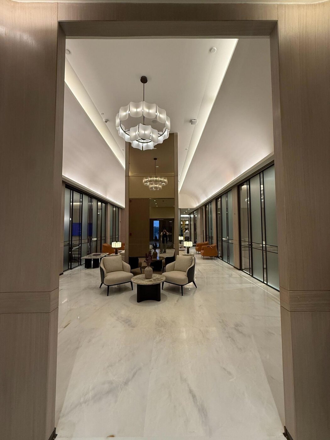 Conscient office marble hallway with chandeliers