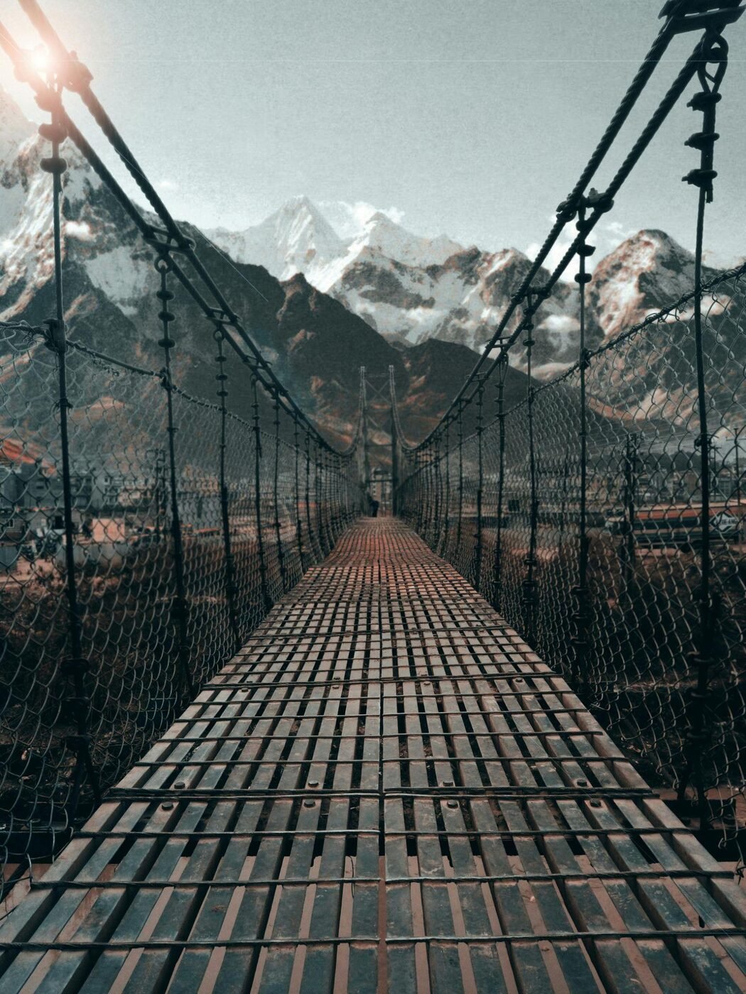 A suspension bridge crossing the Himalayan mountains